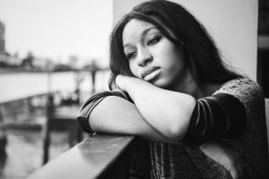 African American woman is sitting and contemplating something